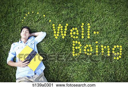 a man lying on the grass View Large Photo Image Stock Image - a man lying on the grass. Fotosearch