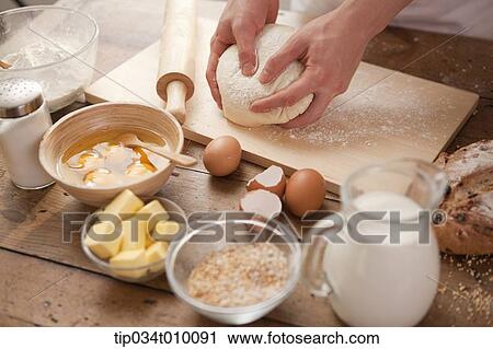 a man making bread with all ingredients on a table View Large Photo Image Stock Image - a man making bread with all ingredients on a table. Fotosearch