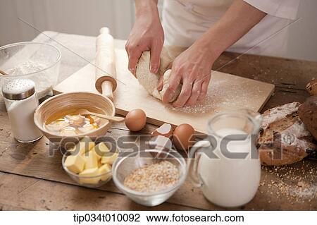 a man making bread with all ingredients on a table View Large Photo Image Stock Image - a man making bread with all ingredients on a table. Fotosearch