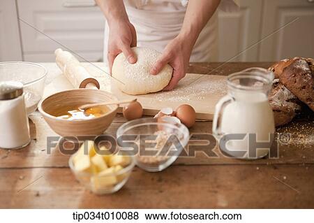 a man making bread with all ingredients on a table View Large Photo Image Stock Photo - a man making bread with all ingredients on a table. Fotosearch
