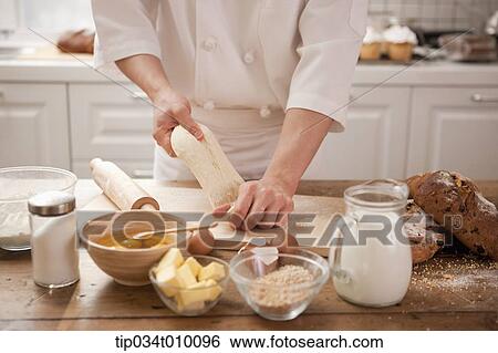 a man making bread with all ingredients on a table View Large Photo Image Stock Photograph - a man making bread with all ingredients on a table. Fotosearch