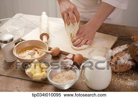 a man making bread with all ingredients on a table View Large Photo Image Stock Photography - a man making bread with all ingredients on a table. Fotosearch