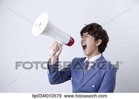Stock Photo - a man shouting through a megaphone. Fotosearch