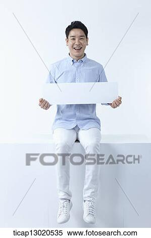 Stock Photography - a man sitting with a blank paper. Fotosearch