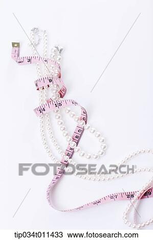 Stock Image - a measurement band wrapped around a pearl necklace. Fotosearch
