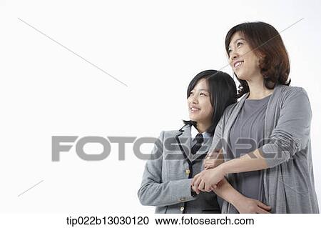 Stock Image - a mother and a daughter in school uniform. Fotosearch