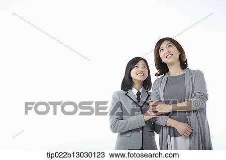 Stock Image - a mother and a daughter in school uniform. Fotosearch