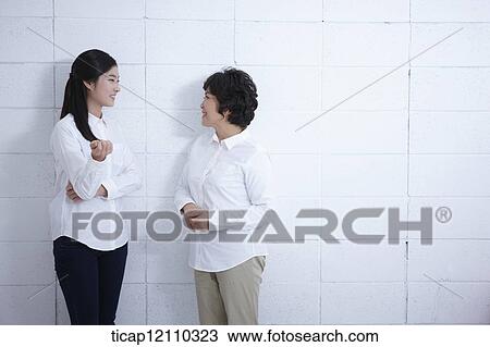 Stock Image - a mother and daughter having a chat. Fotosearch