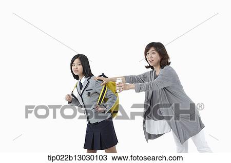 a mother grabbing daughter in a school uniform View Large Photo Image Stock Image - a mother grabbing daughter in a school uniform. Fotosearch