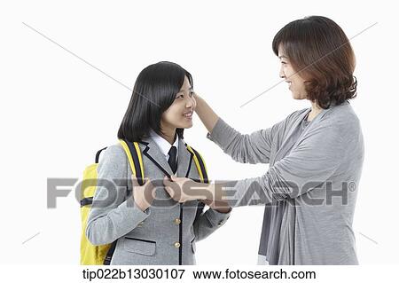 a mother grabbing daughter in a school uniform View Large Photo Image Stock Photo - a mother grabbing daughter in a school uniform. Fotosearch