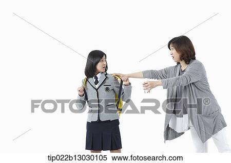 Stock Photography - a mother grabbing daughter in a school uniform. Fotosearch
