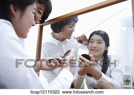 a mother putting on make up for daughter View Large Photo Image Stock Image - a mother putting on make up for daughter. Fotosearch