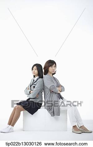 a mother sitting with daughter with a school uniform View Large Photo Image Stock Photograph - a mother sitting with daughter with a school uniform. Fotosearch