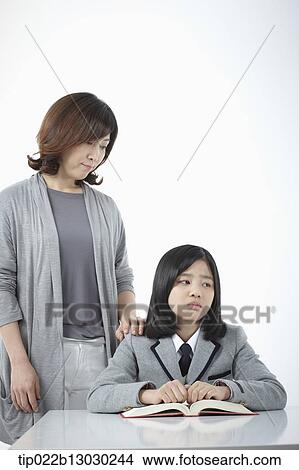 a mother with her daughter doing homework View Large Photo Image Picture - a mother with her daughter doing homework. Fotosearch
