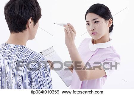 a nurse measuring a patient's body temperature View Large Photo Image Stock Photo - a nurse measuring a patient's body temperature. Fotosearch