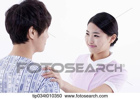 Stock Image - a nurse taking care of a patient. Fotosearch