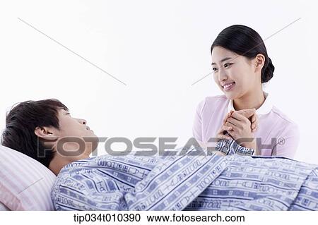 a nurse talking with a patient on a bed View Large Photo Image Stock Image - a nurse talking with a patient on a bed. Fotosearch