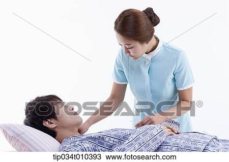 a nurse talking with a patient on a bed View Large Photo Image Stock Image - a nurse talking with a patient on a bed. Fotosearch