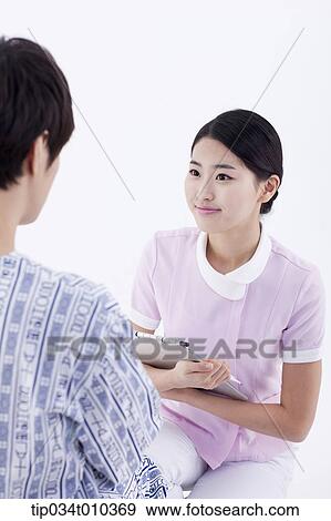 Stock Photo - a nurse talking with a patient. Fotosearch