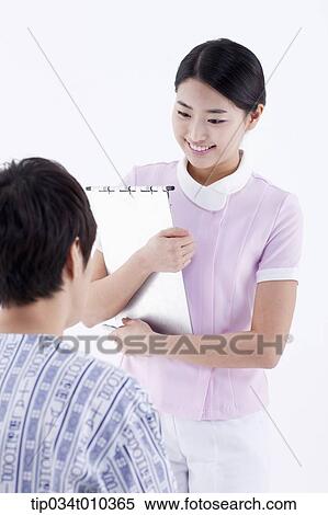 Stock Photography - a nurse talking with a patient. Fotosearch