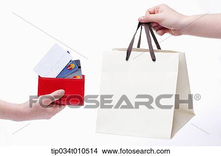 Picture - a person receiving shopping bag after paying. Fotosearch