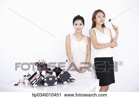 Stock Image - a professional make up artist with make up sets. Fotosearch