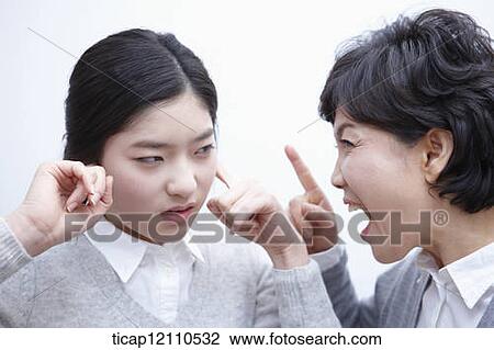 Stock Image - a student blocking ears from mother. Fotosearch