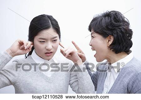 Stock Photo - a student blocking ears from mother. Fotosearch