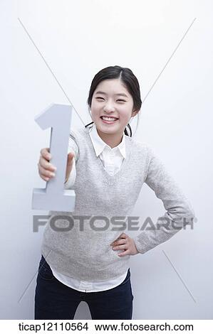 Picture - a student holding number one block. Fotosearch
