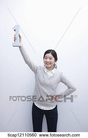 Stock Image - a student holding number one block. Fotosearch