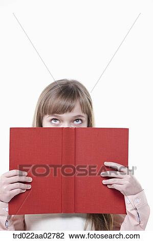 a student in uniform covering her face with a book View Large Photo Image Stock Image - a student in uniform covering her face with a book. Fotosearch