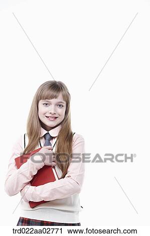a student in uniform holding a book on white background View Large Photo Image Stock Image - a student in uniform holding a book on white background. Fotosearch