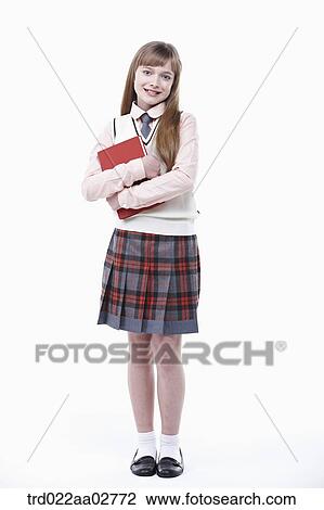 a student in uniform holding a book on white background View Large Photo Image Stock Image - a student in uniform holding a book on white background. Fotosearch