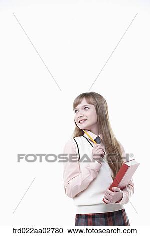 a student in uniform holding a book on white background View Large Photo Image Stock Image - a student in uniform holding a book on white background. Fotosearch