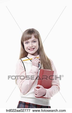 a student in uniform holding a book on white background View Large Photo Image Stock Photo - a student in uniform holding a book on white background. Fotosearch