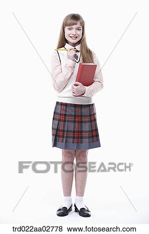Stock Photo - a student in uniform holding a book on white background. Fotosearch