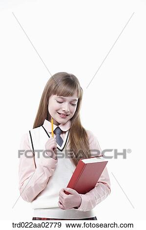 a student in uniform holding a book on white background View Large Photo Image Stock Photo - a student in uniform holding a book on white background. Fotosearch