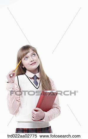 a student in uniform holding a book on white background View Large Photo Image Stock Photography - a student in uniform holding a book on white background. Fotosearch