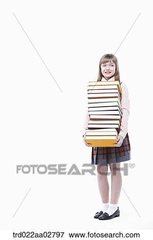 a student in uniform holding a pile of books View Large Photo Image Stock Photo - a student in uniform holding a pile of books. Fotosearch