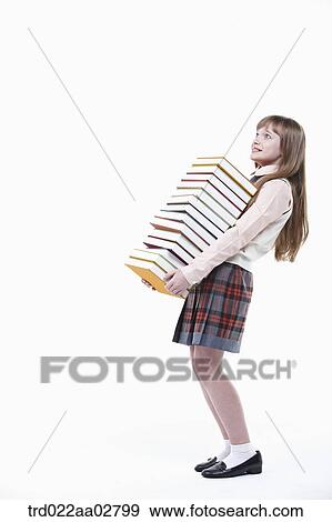 a student in uniform holding a pile of books View Large Photo Image Stock Photo - a student in uniform holding a pile of books. Fotosearch