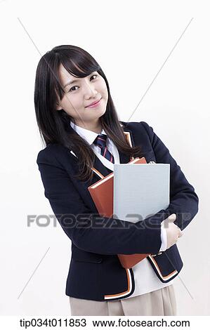a student in uniform holding books View Large Photo Image Stock Image - a student in uniform holding books. Fotosearch
