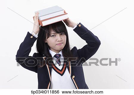 a student in uniform holding books View Large Photo Image Stock Photograph - a student in uniform holding books. Fotosearch