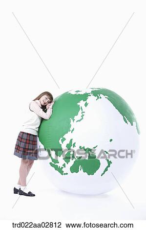 a student in uniform leaning on a globe View Large Photo Image Stock Image - a student in uniform leaning on a globe. Fotosearch
