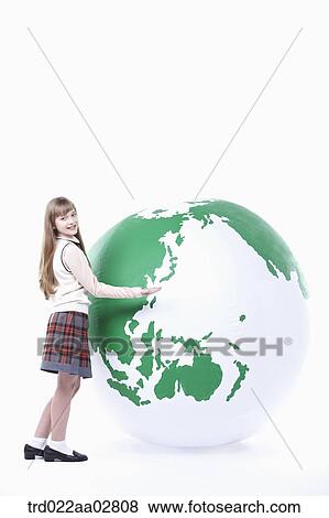 a student in uniform leaning on a globe View Large Photo Image Stock Photo - a student in uniform leaning on a globe. Fotosearch