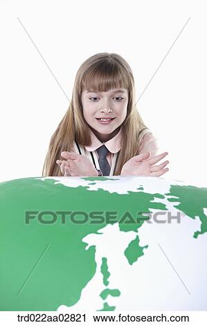 a student in uniform leaning on top of a globe View Large Photo Image Stock Image - a student in uniform leaning on top of a globe. Fotosearch