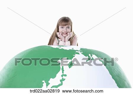 a student in uniform leaning on top of a globe View Large Photo Image Stock Photo - a student in uniform leaning on top of a globe. Fotosearch