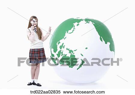 a student in uniform next to a globe with magnifier View Large Photo Image Stock Photography - a student in uniform next to a globe with magnifier. Fotosearch