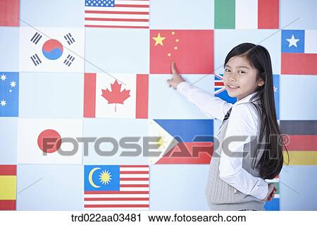 a student in uniform pointing at one of international flags View Large Photo Image Stock Image - a student in uniform pointing at one of international flags. Fotosearch