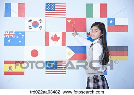 a student in uniform pointing at one of international flags View Large Photo Image Stock Image - a student in uniform pointing at one of international flags. Fotosearch