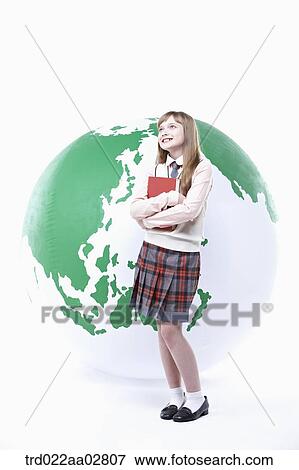 a student in uniform posing in front of a globe View Large Photo Image Stock Photo - a student in uniform posing in front of a globe. Fotosearch
